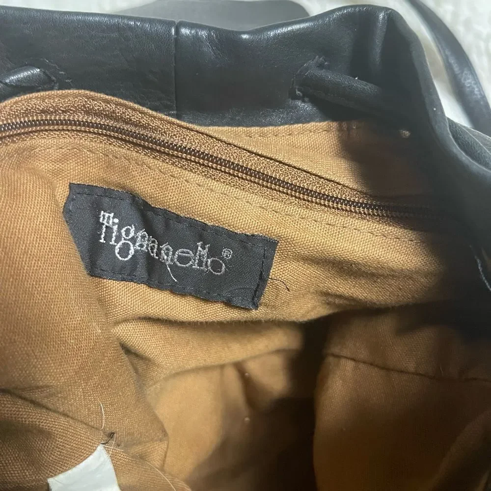 Tignanello Leather Black small Backpack string straps closure.